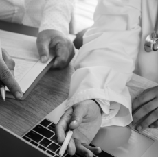 Close up of a healthcare professional with a pen in hand.