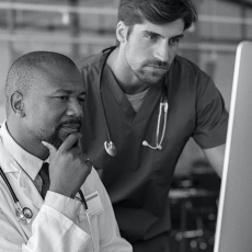 Healthcare professionals looking at a computer.